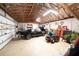 Spacious garage featuring a car, tool storage, and exposed wood framing at 6448 Country Club Rd, Wesley Chapel, FL 33544