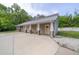 The two-car detached garage features a covered area for additional parking and side entrance at 6448 Country Club Rd, Wesley Chapel, FL 33544