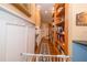 Charming hallway with built-in shelving, wood floors, and elegant wainscoting details at 6448 Country Club Rd, Wesley Chapel, FL 33544