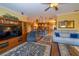 Spacious living room with hardwood floors, stylish area rug, comfortable seating and plenty of natural light at 6448 Country Club Rd, Wesley Chapel, FL 33544