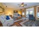 Cozy living room with hardwood floors, stylish area rug, comfortable seating and access to the outdoors at 6448 Country Club Rd, Wesley Chapel, FL 33544