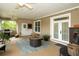Relaxing covered patio with a ceiling fan, grill, and comfortable seating area at 6448 Country Club Rd, Wesley Chapel, FL 33544