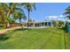 Lush backyard boasts a beautiful pool, brick patio, and manicured lawn at 6667 28Th S St, St Petersburg, FL 33712