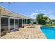 Backyard boasts a beautiful brick patio with a pool and seating area at 6667 28Th S St, St Petersburg, FL 33712