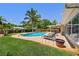 Large pool in backyard surrounded by palm trees, brick patio, and lounge chairs at 6667 28Th S St, St Petersburg, FL 33712