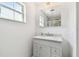 Bathroom featuring a gray vanity with marble countertop and mirrored medicine cabinet at 6667 28Th S St, St Petersburg, FL 33712