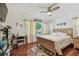 Bright bedroom with wooden floors, ceiling fan, desk, large window, and natural light at 6667 28Th S St, St Petersburg, FL 33712