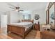 Well lit bedroom featuring a wooden bed frame, ceiling fan, and wood flooring at 6667 28Th S St, St Petersburg, FL 33712