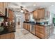Traditional kitchen with wooden cabinets, black countertops, stainless steel appliances, and white tile flooring at 6667 28Th S St, St Petersburg, FL 33712