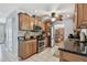 Classic kitchen with granite countertops, stainless steel appliances, wood cabinets, and a view into the dining room at 6667 28Th S St, St Petersburg, FL 33712