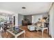 Open-concept living room with hardwood floors, piano, and comfortable seating, offering an inviting and spacious atmosphere at 6667 28Th S St, St Petersburg, FL 33712