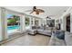 Bright living room with a view of the pool, tile floors, and unique ceiling fans at 6667 28Th S St, St Petersburg, FL 33712