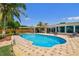 Backyard features a sparkling pool, lounge chairs, and a covered patio perfect for outdoor entertaining at 6667 28Th S St, St Petersburg, FL 33712
