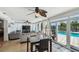 Bright sunroom offering water views and modern fan, complete with a table and seating area at 6667 28Th S St, St Petersburg, FL 33712