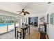 Bright sunroom with tiled floors and seating areas overlooking the outdoor swimming pool at 6667 28Th S St, St Petersburg, FL 33712