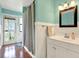Bright bathroom featuring a vanity with white cabinets, modern fixtures and a stylish framed mirror above at 7500 141St St, Seminole, FL 33776