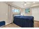 Comfortable bedroom featuring natural light, wood floors, closet, and soothing wall art for a relaxing space at 7500 141St St, Seminole, FL 33776