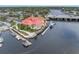 Aerial view features a waterfront restaurant with docks and beautiful landscaping, enhancing the coastal appeal at 7819 Chasco St, Port Richey, FL 34668