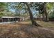 Large backyard features mature shade trees, providing a natural setting for outdoor relaxation at 7819 Chasco St, Port Richey, FL 34668