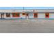Front exterior view of Sunset Landing Marina with large front windows, parking and orange design accents at 7819 Chasco St, Port Richey, FL 34668