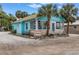 Charming Marina Parking house with a sign, a glassed-in porch and rock detailing at 7819 Chasco St, Port Richey, FL 34668