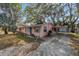 Charming home featuring mature landscaping, a carport, and a welcoming facade at 7819 Chasco St, Port Richey, FL 34668