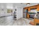 Open kitchen with stainless steel appliances and an eat-in area with large windows at 7819 Chasco St, Port Richey, FL 34668