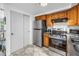 Close-up of the kitchen featuring stainless steel appliances and light oak cabinetry at 7819 Chasco St, Port Richey, FL 34668