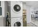 Laundry area with stackable washer and dryer, maximizing space and functionality, conveniently located near a window at 7819 Chasco St, Port Richey, FL 34668