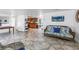 Bright living room featuring tile floors, natural light, coastal decor and kitchen in background at 7819 Chasco St, Port Richey, FL 34668