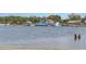 Picturesque waterfront featuring boats docked along the water, lush trees, and serene atmosphere at 7819 Chasco St, Port Richey, FL 34668