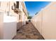 A stone-tiled backyard is surrounded by a white fence at 810 W Whatley Pl, Tampa, FL 33604