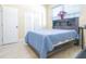 Bedroom with blue quilt on bed, a window with blinds, and tiled floor at 810 W Whatley Pl, Tampa, FL 33604