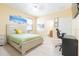 Bedroom with a queen bed, desk, and connected bathroom at 810 W Whatley Pl, Tampa, FL 33604