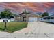 Charming single-story home featuring a well-manicured lawn and a classic two-car garage at 810 W Whatley Pl, Tampa, FL 33604