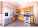 Functional kitchen featuring stainless steel appliances, wooden cabinets, and granite countertops at 810 W Whatley Pl, Tampa, FL 33604