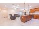 An open-plan living room and kitchen with a granite island, tile flooring, and comfortable seating at 810 W Whatley Pl, Tampa, FL 33604
