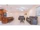 Open living room with tile floors, comfortable seating, a bar area, and modern lighting fixtures at 810 W Whatley Pl, Tampa, FL 33604