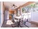 Covered patio with outdoor dining set, ceiling fan, and access to the kitchen, perfect for entertaining at 810 W Whatley Pl, Tampa, FL 33604