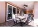 Comfortable patio with outdoor dining set and ceiling fan, adjacent to a kitchen area at 810 W Whatley Pl, Tampa, FL 33604