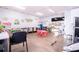 Spacious playroom with colorful decor, including tables and chairs, educational posters, and play equipment at 810 W Whatley Pl, Tampa, FL 33604