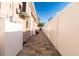 Paver walkway along the side of the home featuring a new vinyl privacy fence and outdoor utilities at 810 W Whatley Pl, Tampa, FL 33604