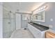 Bright bathroom with tiled floors, walk-in shower, and vanity with large countertop at 8420 Orient Ne Way, St Petersburg, FL 33702