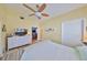 Bedroom showcasing wood-look floors, ceiling fan, and ample closet space at 8420 Orient Ne Way, St Petersburg, FL 33702