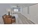 Bright bedroom featuring hardwood floors, ceiling fan, a window with blinds, and lots of closet space at 8420 Orient Ne Way, St Petersburg, FL 33702
