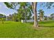 Well-manicured lawn and verdant trees accentuate the facade of this home at 8420 Orient Ne Way, St Petersburg, FL 33702