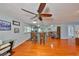 Open-concept living room featuring hardwood floors, a ceiling fan, and a view into the modern kitchen at 8420 Orient Ne Way, St Petersburg, FL 33702