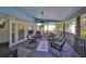 Relaxing covered patio featuring comfortable seating, ceiling fan, and views of the surrounding neighborhood at 8420 Orient Ne Way, St Petersburg, FL 33702