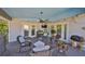 Cozy covered patio with comfortable seating, a ceiling fan, and string lights for a relaxing ambiance at 8420 Orient Ne Way, St Petersburg, FL 33702