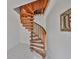 Unique spiral wooden staircase with white-tiled floor and natural lighting at 8420 Orient Ne Way, St Petersburg, FL 33702